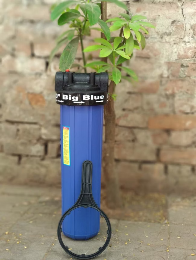 Big Blue filter housing mounted on an outdoor wall