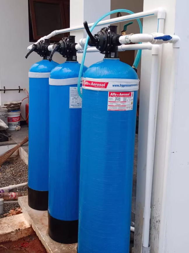 Twin-tank water treatment system with safety labels
